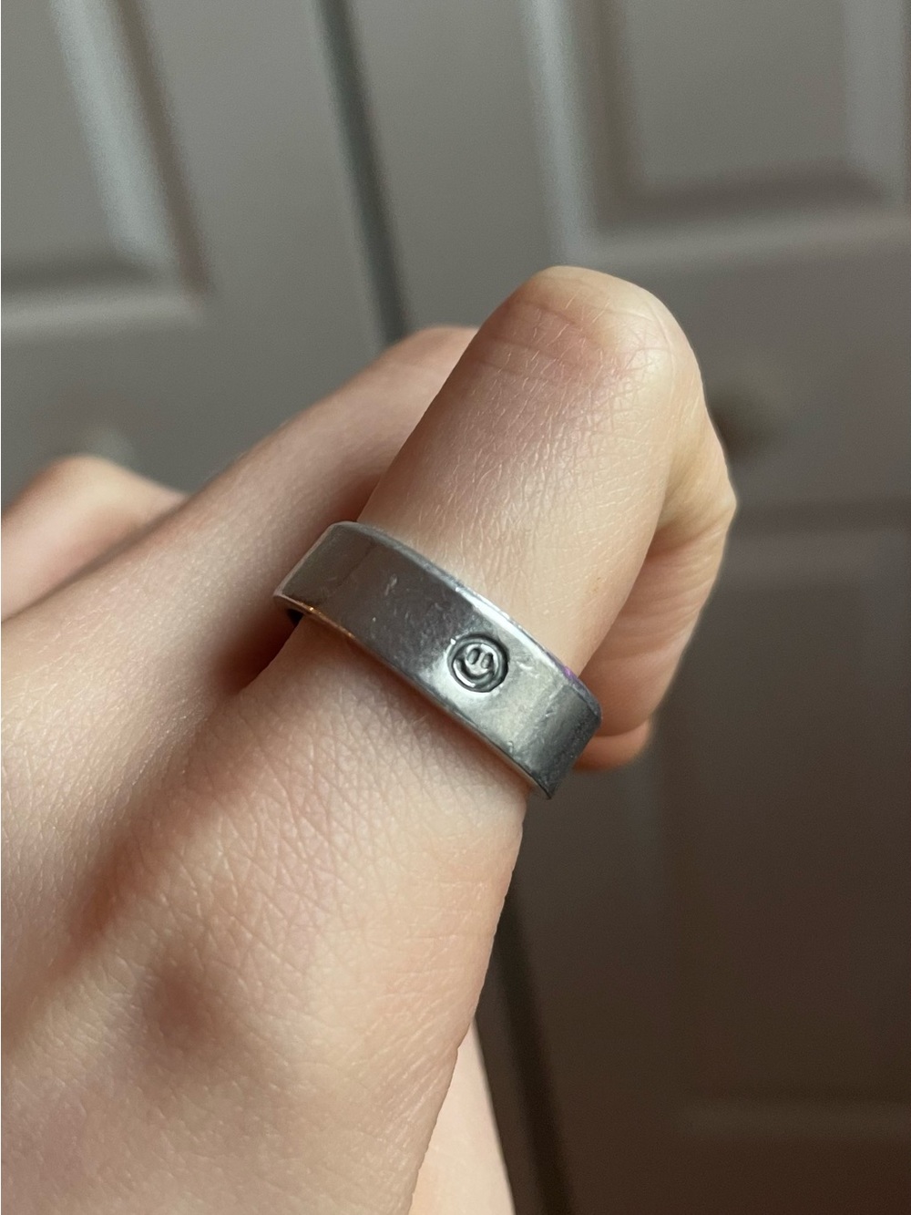 Silver Band Ring with Small Smiley Face Logo